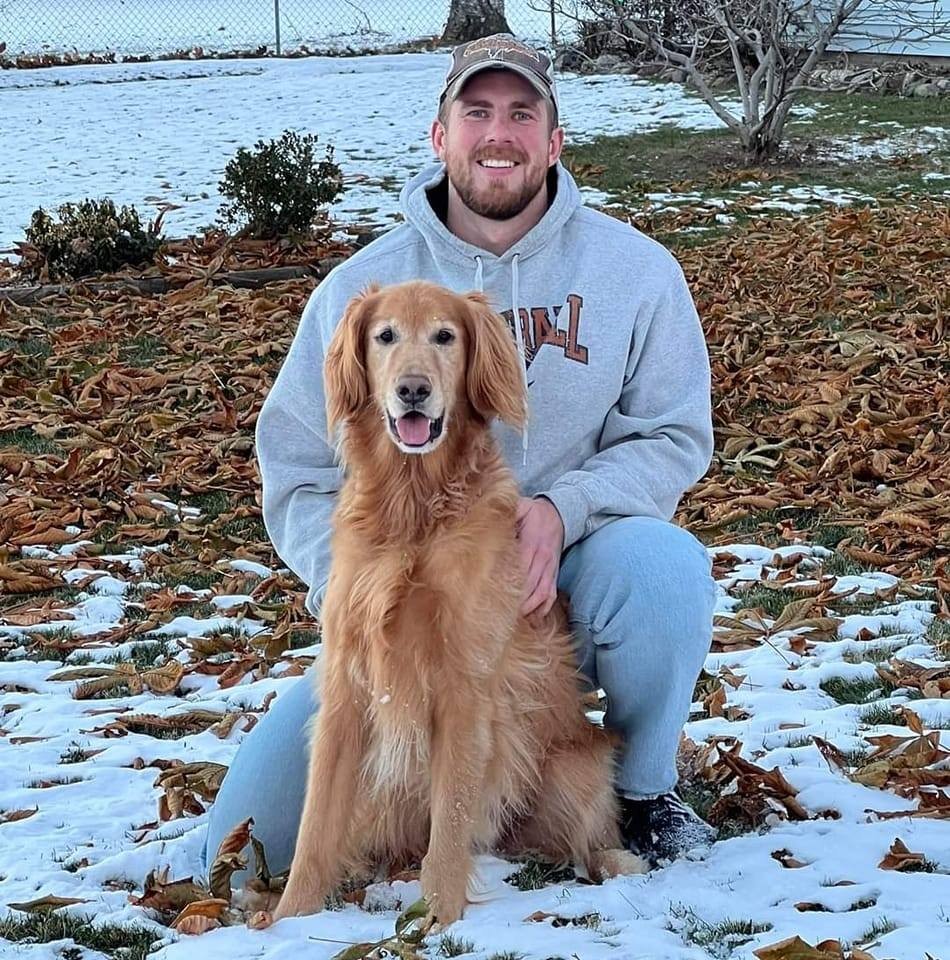 Jordan Van Calster with his golden retriever Tucker
